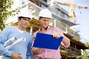 Male architects with blueprint and clipboard working at site - Architecture GOLN [ architecturegoln.com ]